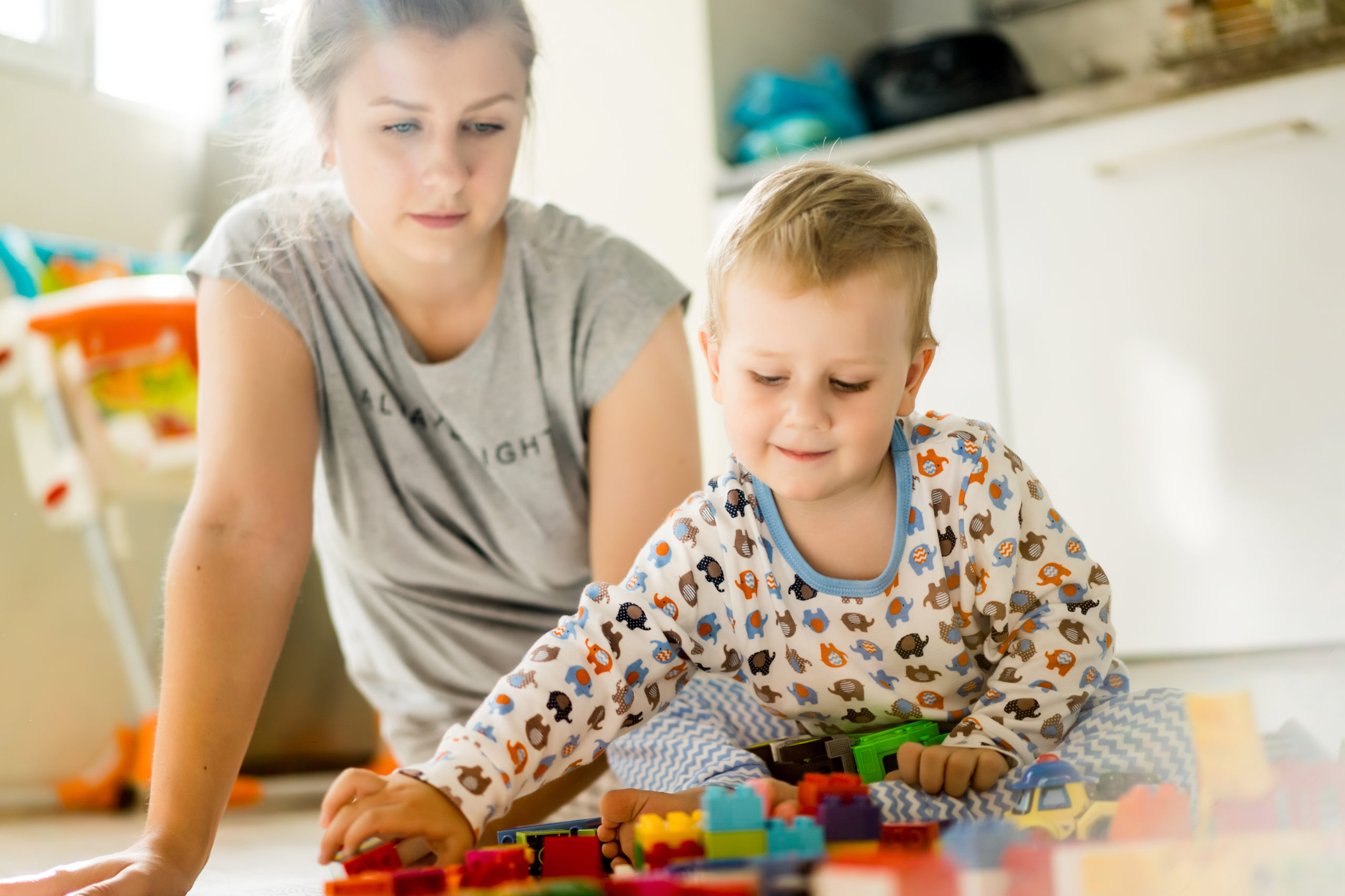 boy with mom playing in colorful building kit